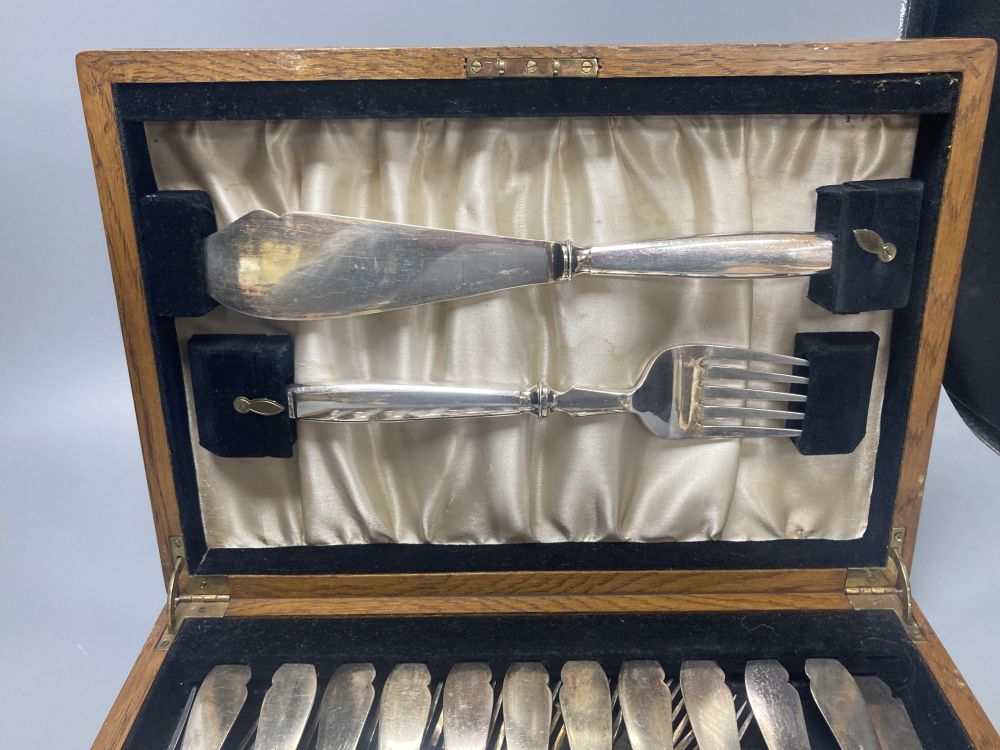 A cased Elkington plated canteen of Rochester-pattern cutlery, near complete, and similar oak cased set of twelve fish knives and forks